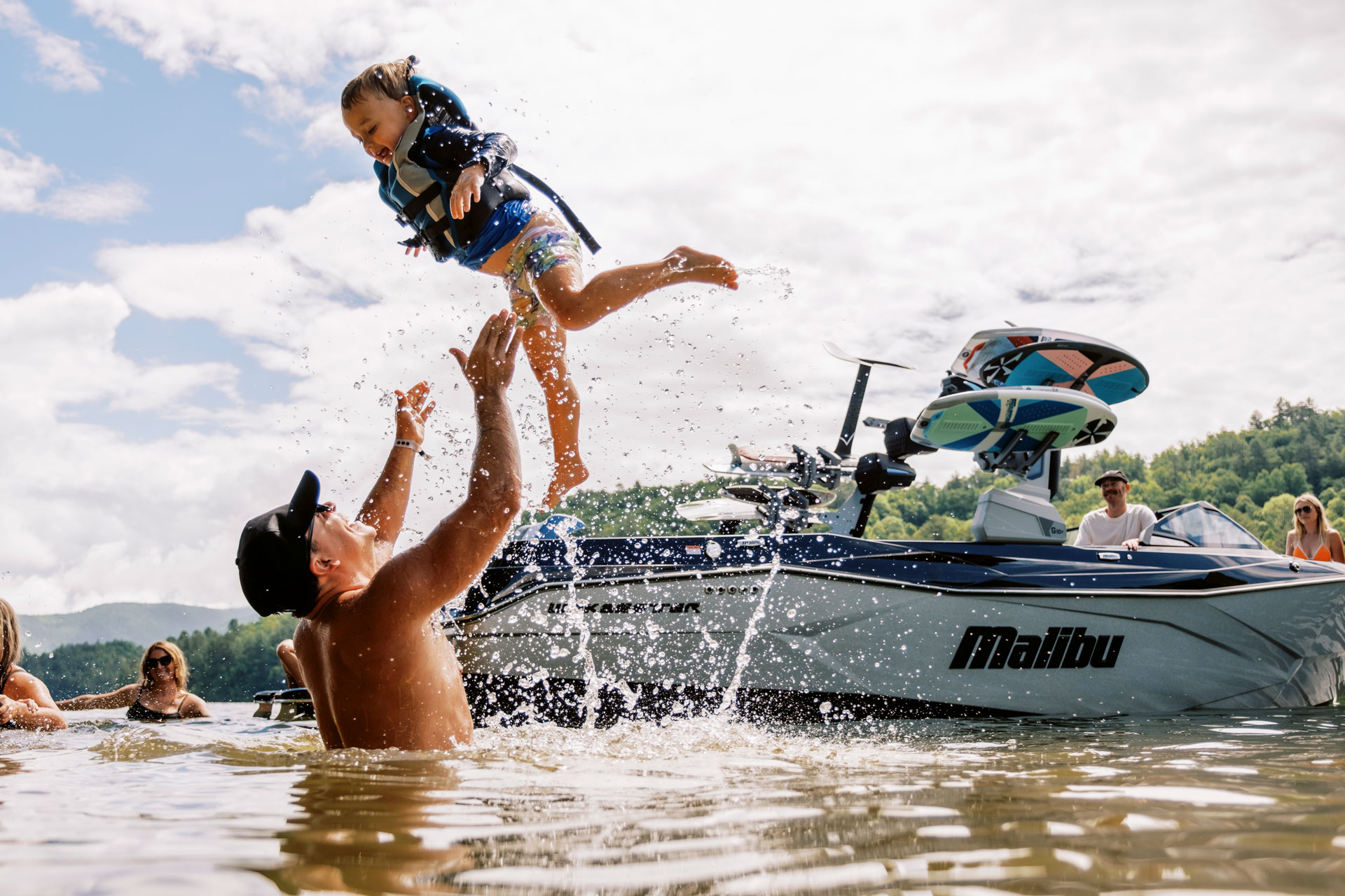 Family on a Malibu enjoying their time on the water